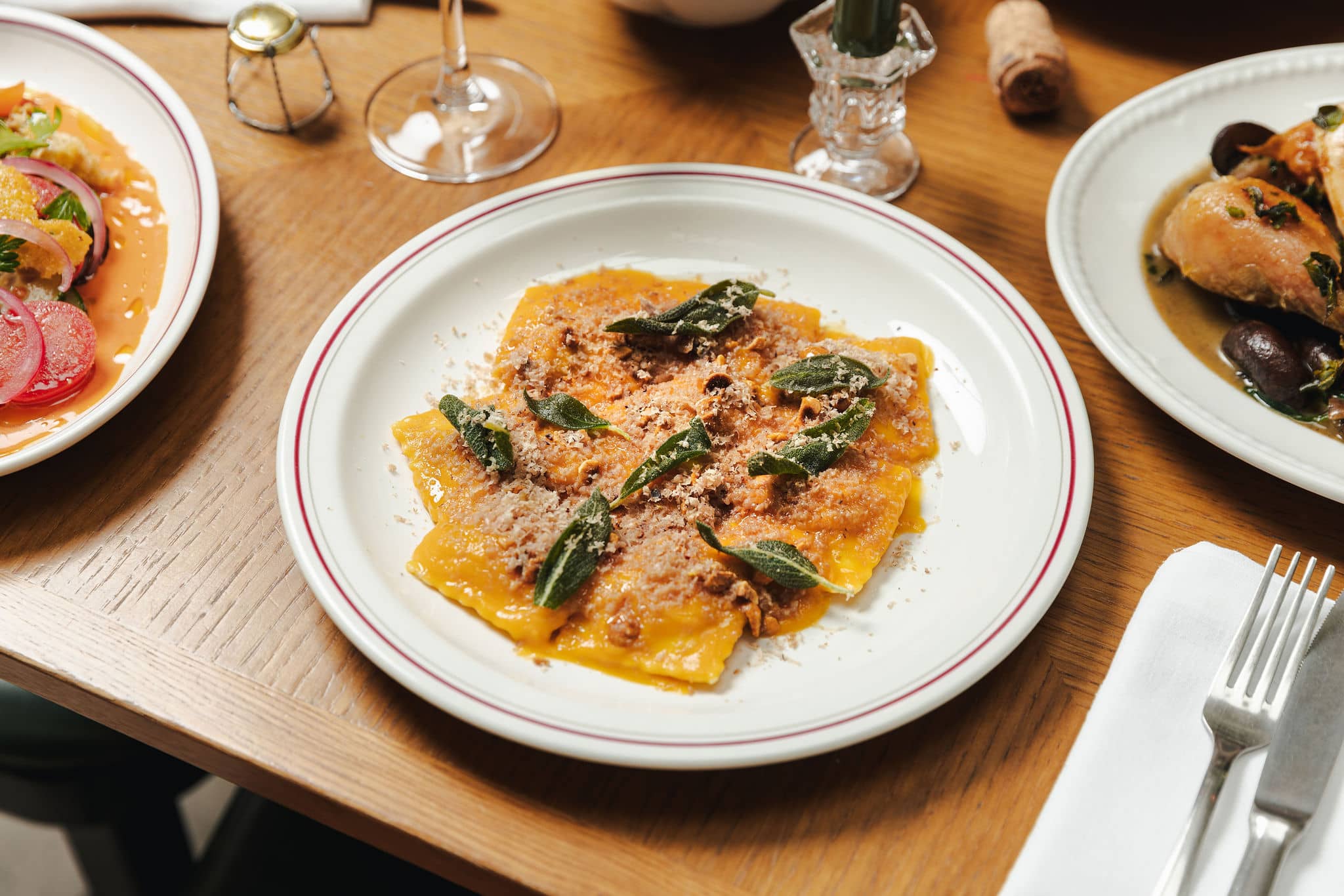Plate of ravioli with meat ragu, crispy sage leaves, and grated parmesan at Mortimer House Kitchen.